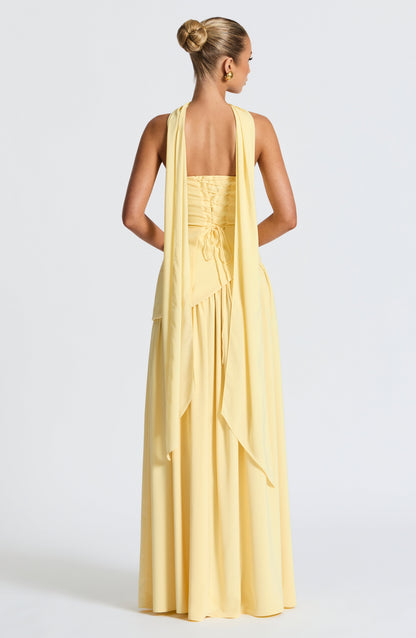 Pale yellow strapless maxi dress back view with corset detail and slit