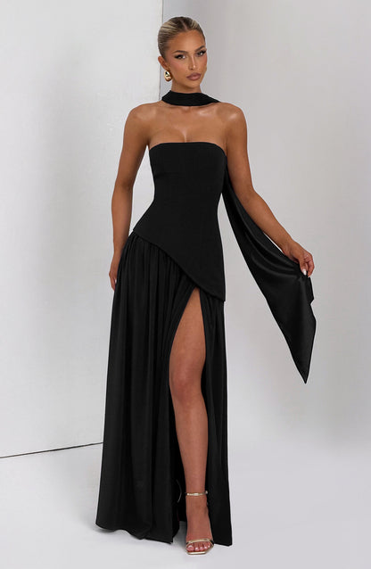 Black strapless maxi dress with asymmetrical draped sleeve and thigh slit