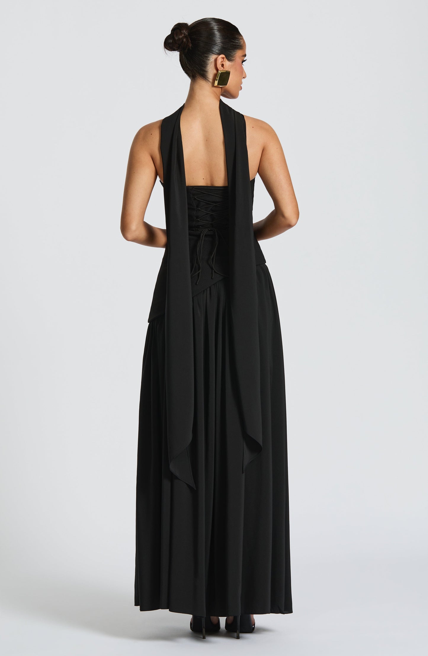 Black strapless maxi dress with ruched bodice and high slit, back view