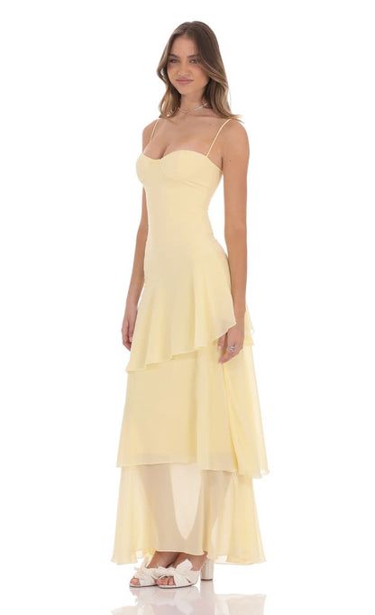 Cream colored spaghetti strap maxi dress with sweetheart bodice and tiered flowing skirt